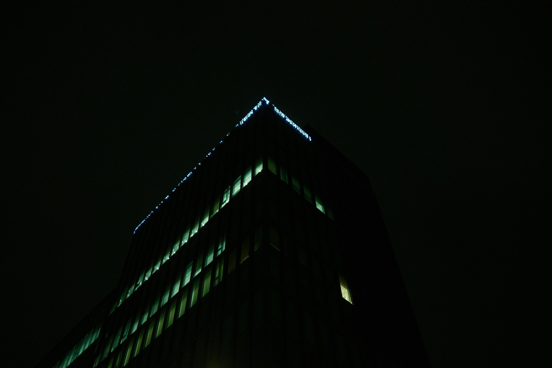 A very tall building lit up at night