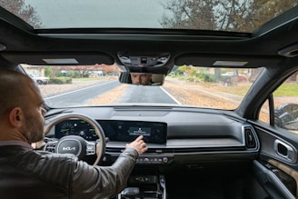 A man driving a car down a road