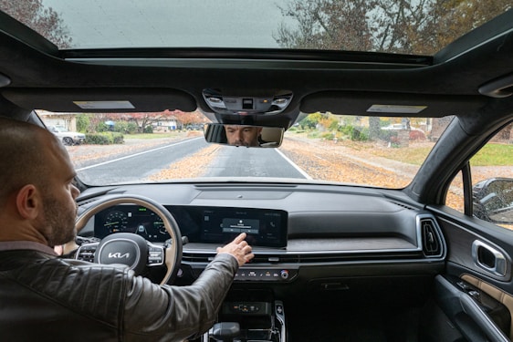 A man driving a car down a road