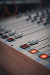 A close up of a sound mixing console