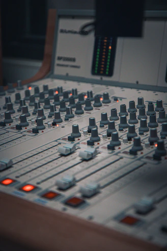 A sound mixing console with many knobs