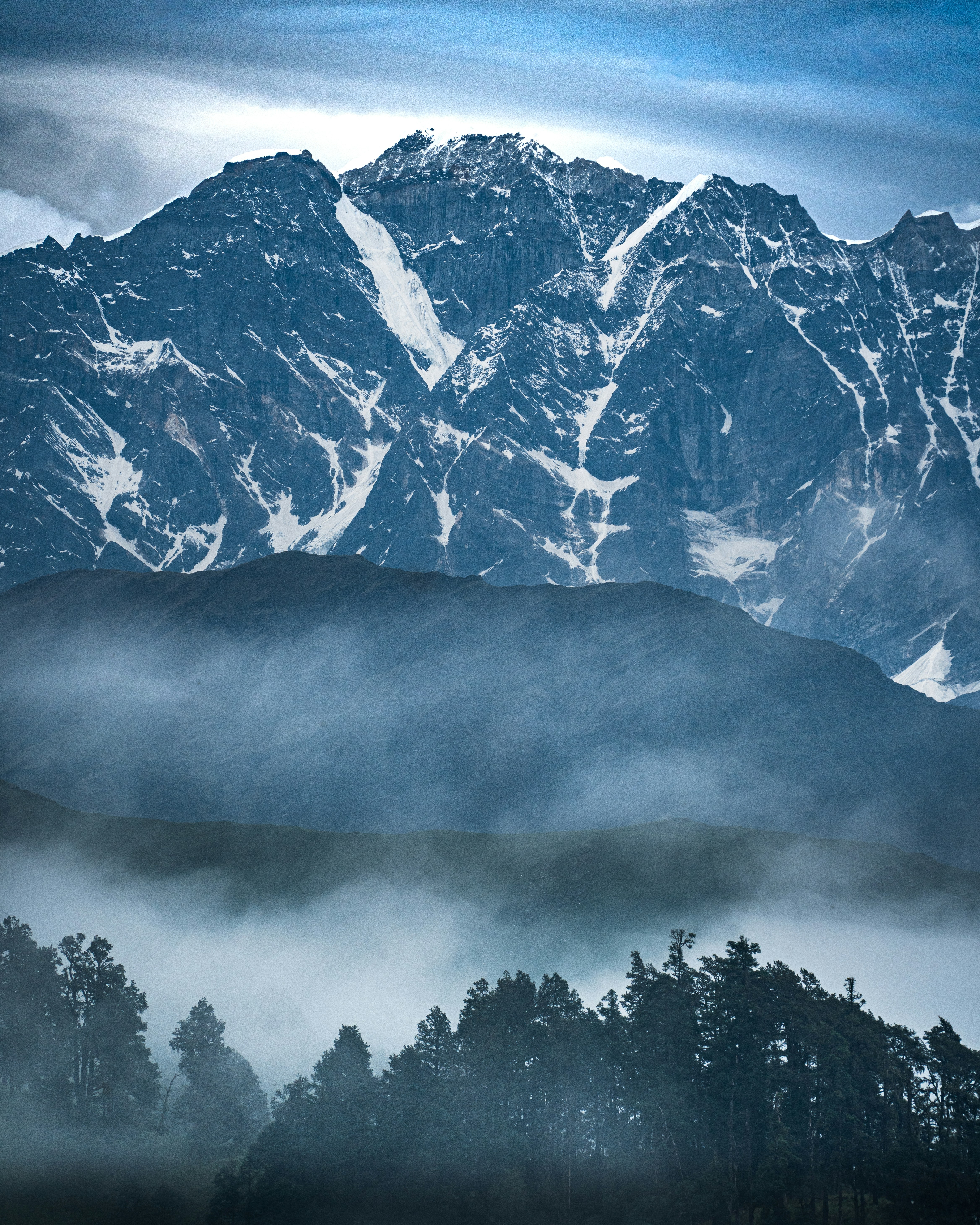 A view of a mountain range covered in fog