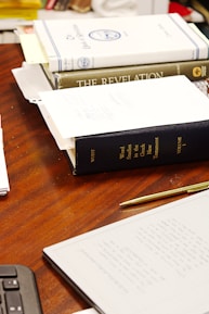 A desk with three books and a calculator
