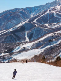 A man riding skis down a snow covered slope