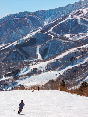 A man riding skis down a snow covered slope