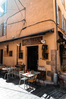 A building with tables and chairs outside of it
