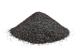 A pile of black sand on a white background