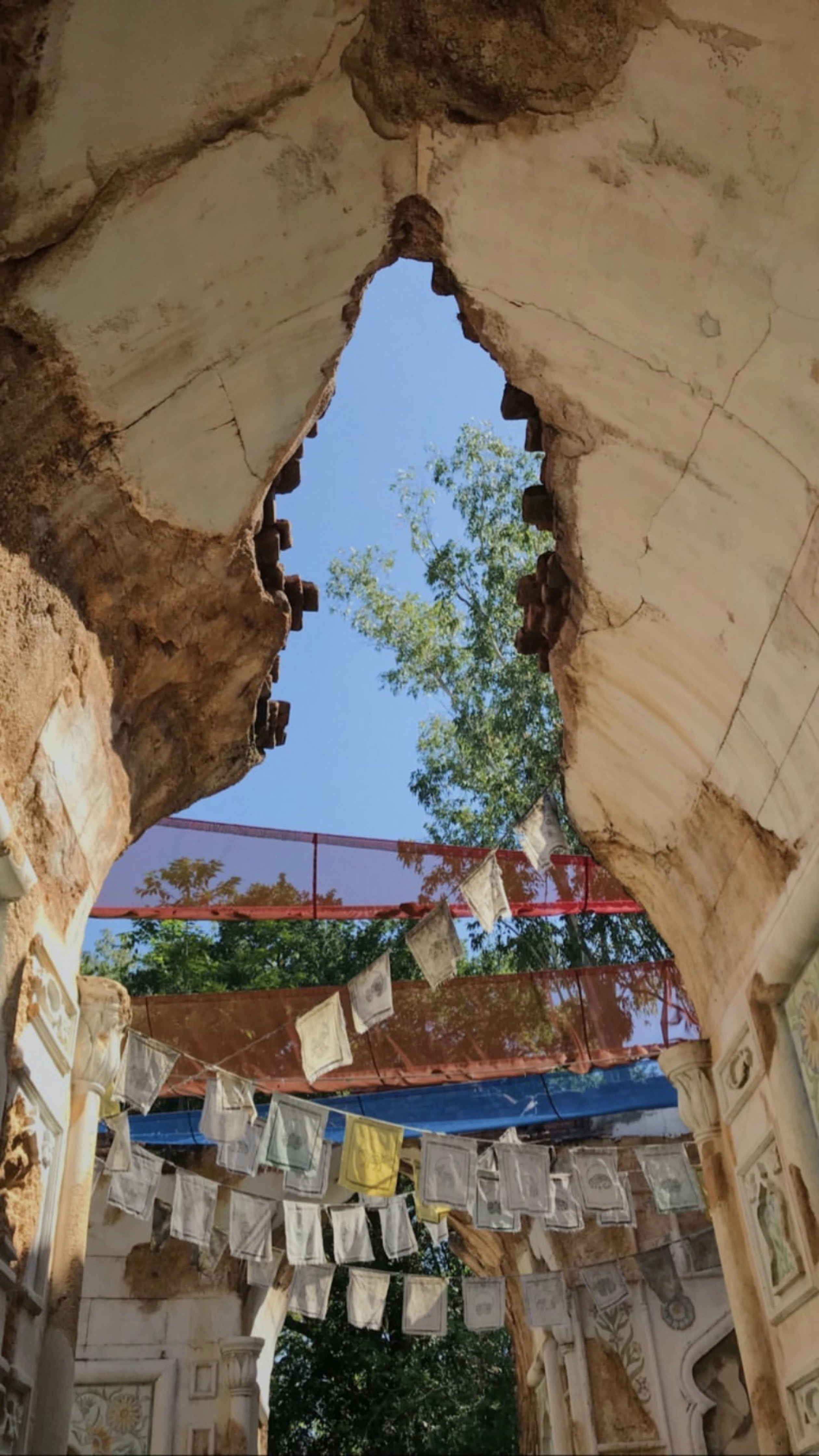 An arch in a building with pictures hanging from it