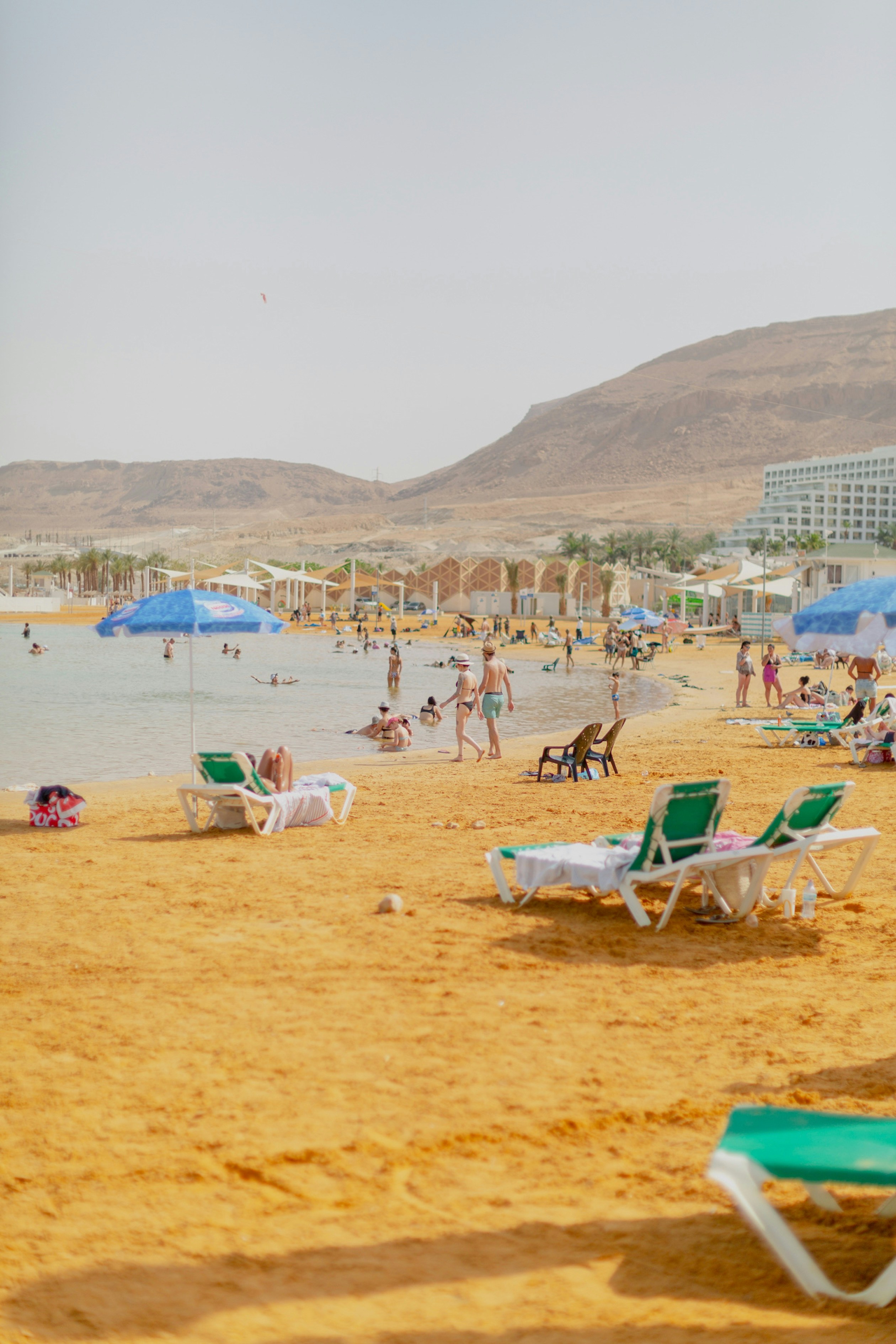 A beach filled with lots of people and umbrellas