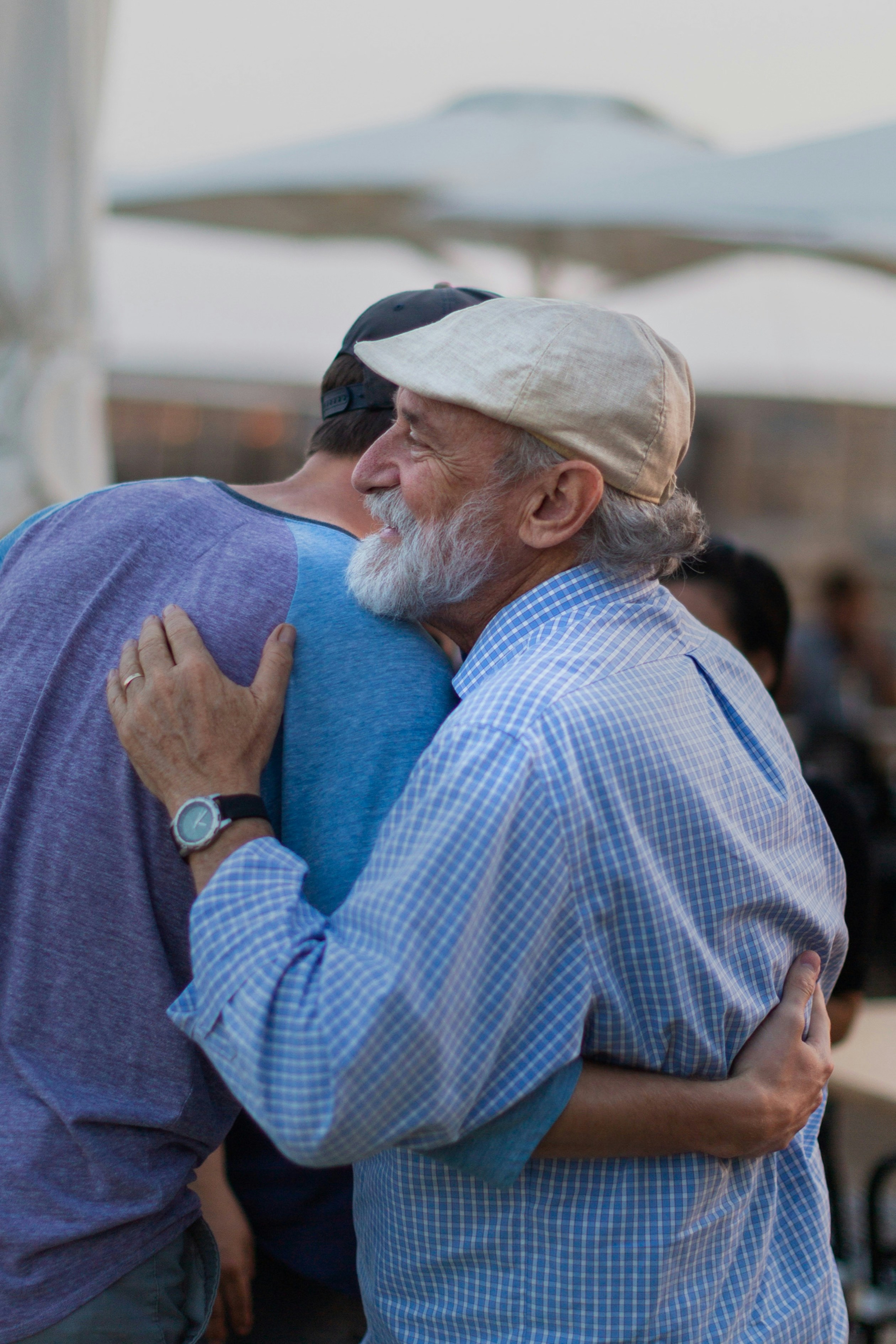 A couple of men hugging each other outside