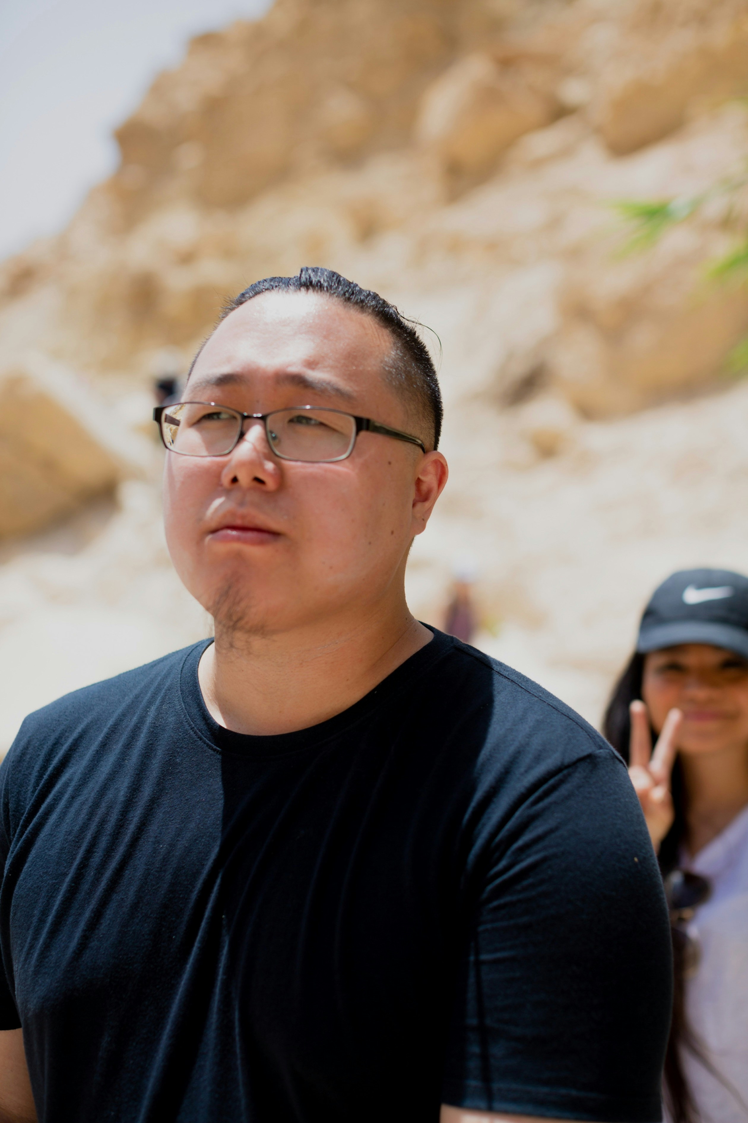 A man standing next to a woman on a cell phone