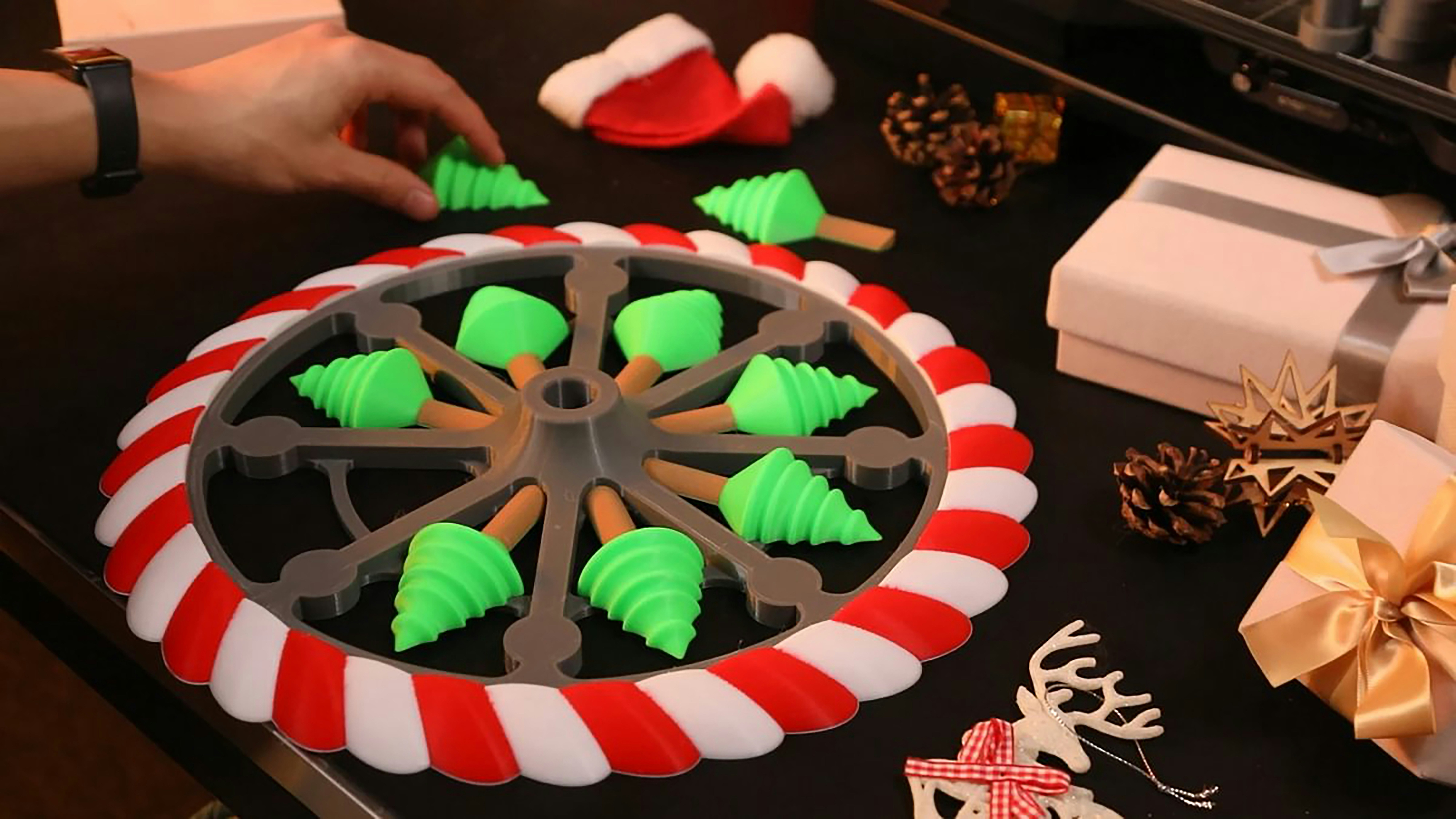 3D-printed Christmas Ferris wheel featuring festive green trees for holiday decor.