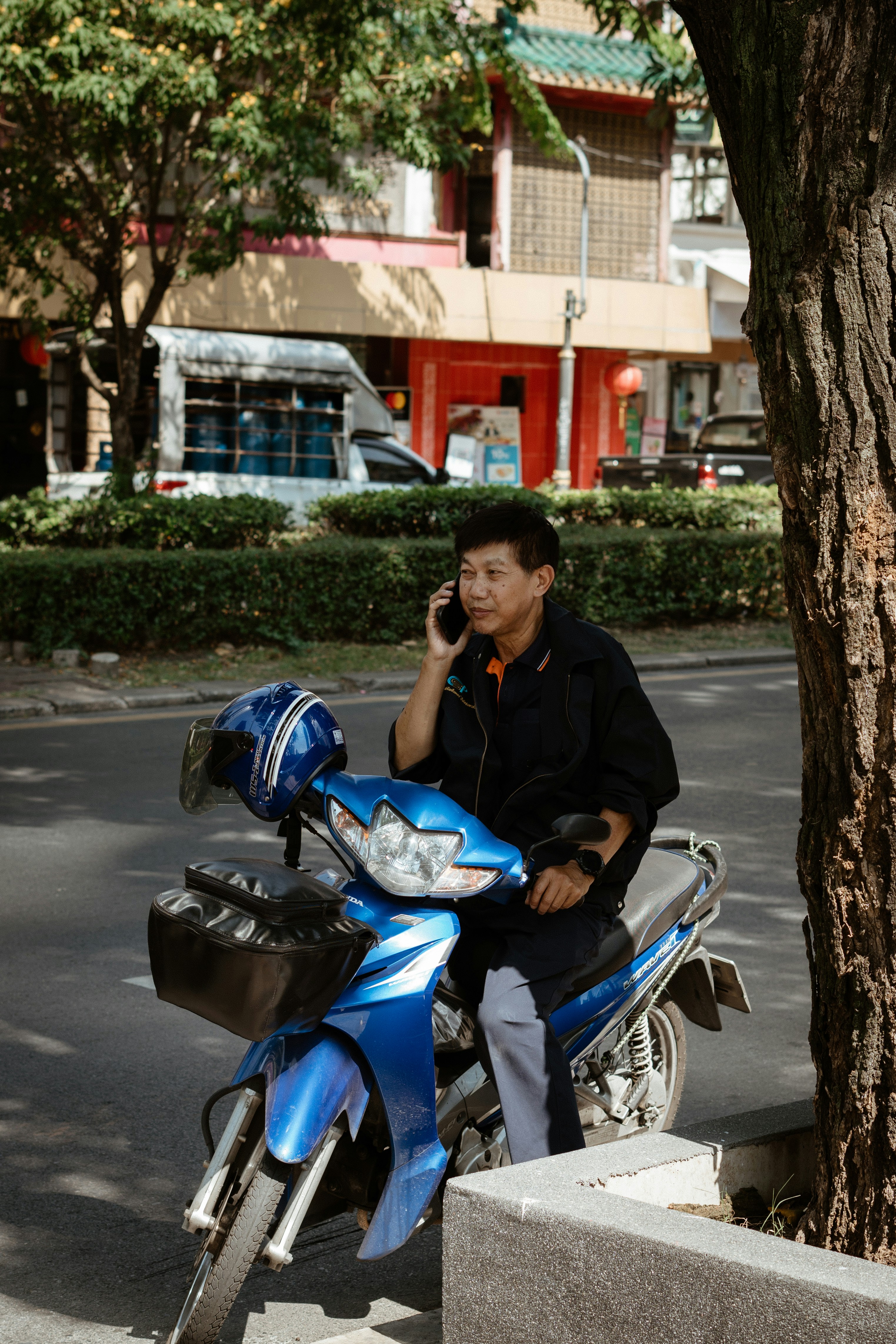 A man sitting on a motorcycle talking on a cell phone