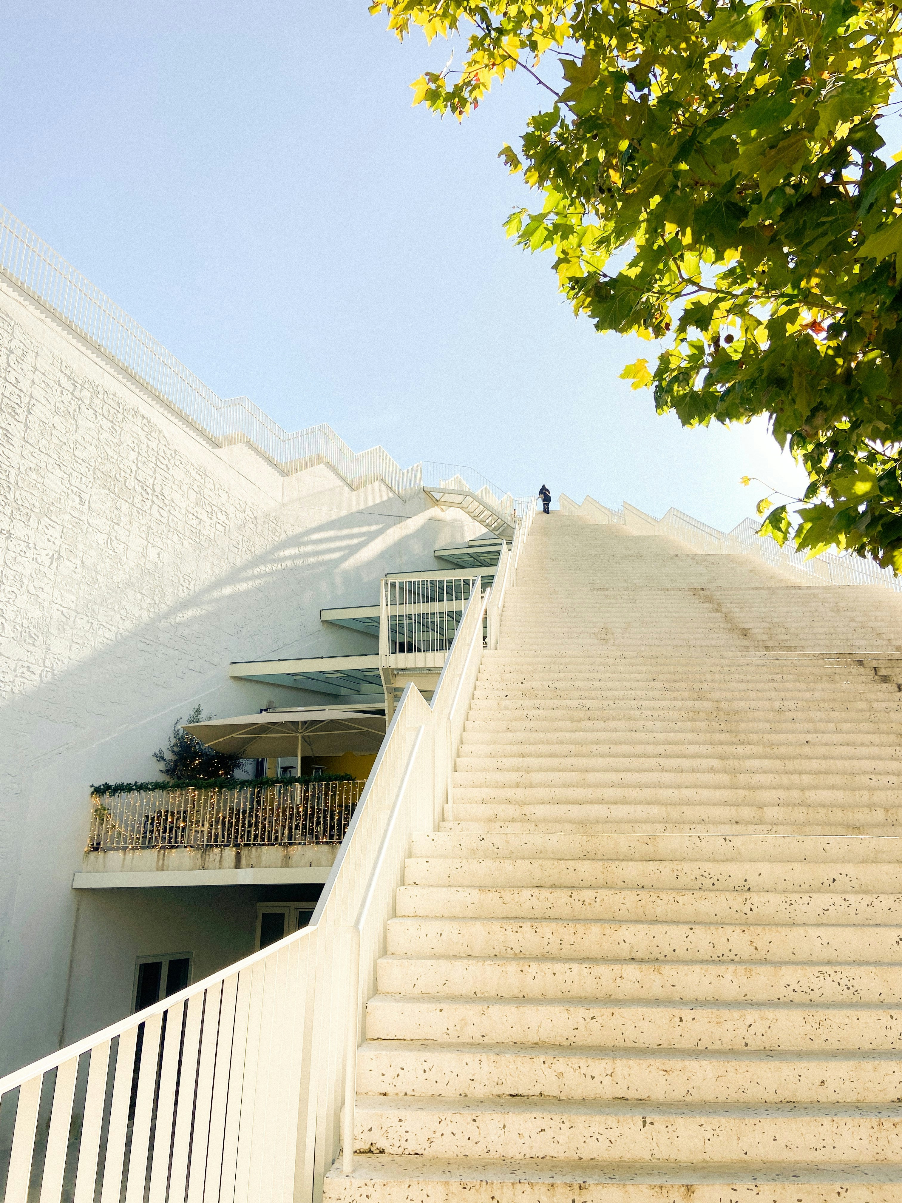 A white building with stairs leading up to it