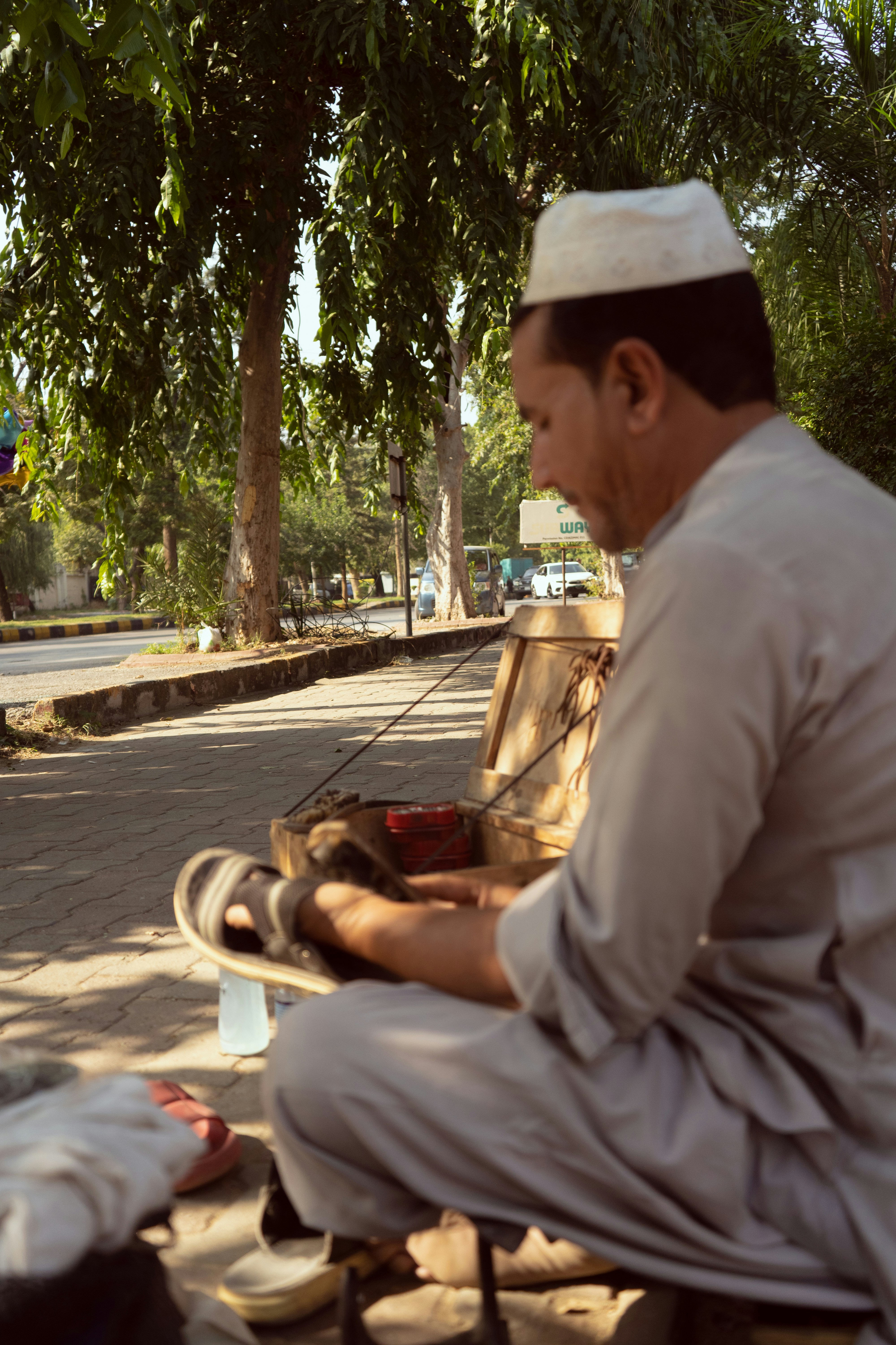 A man sitting on a bench next to a dog