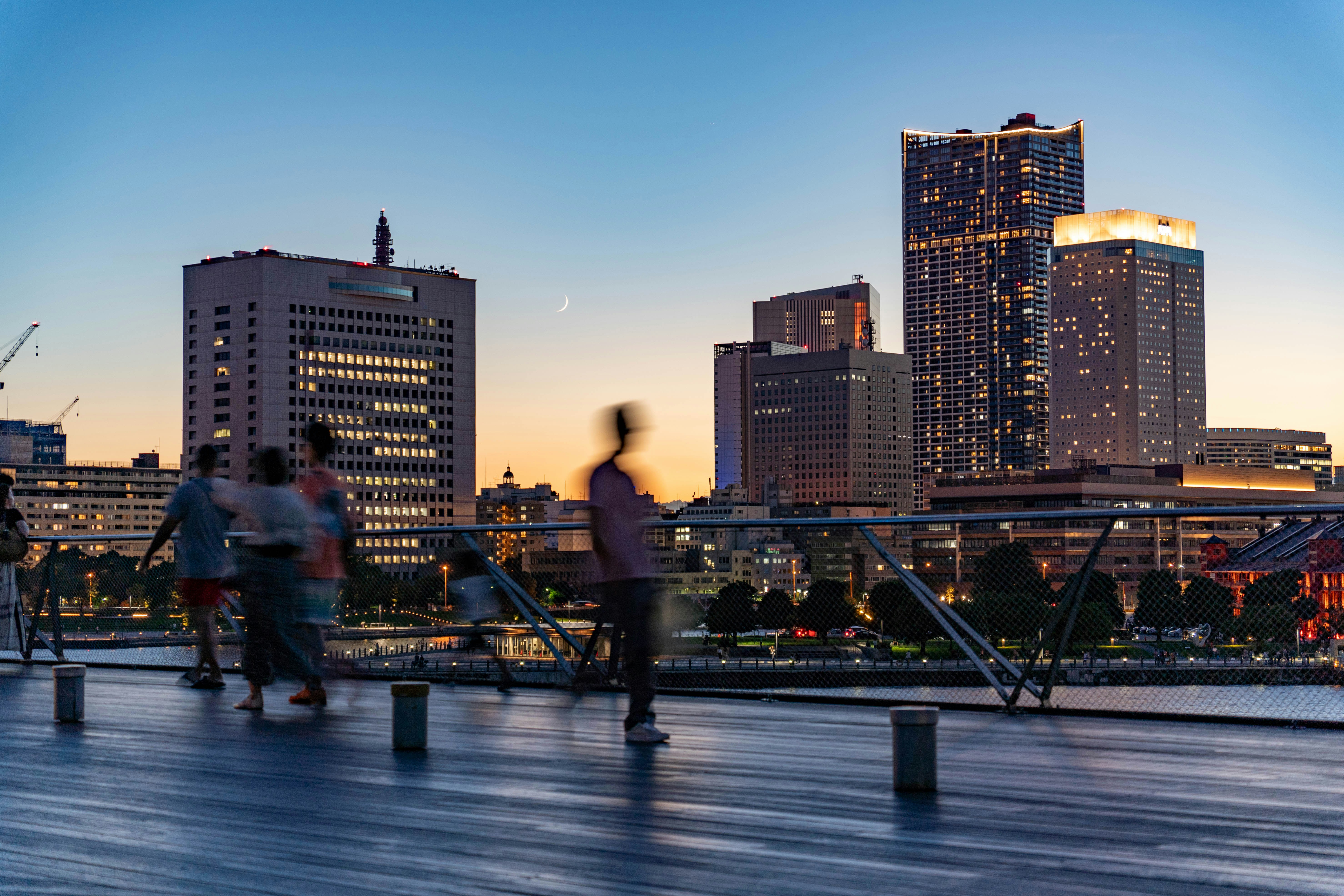 A group of people walking across a bridge