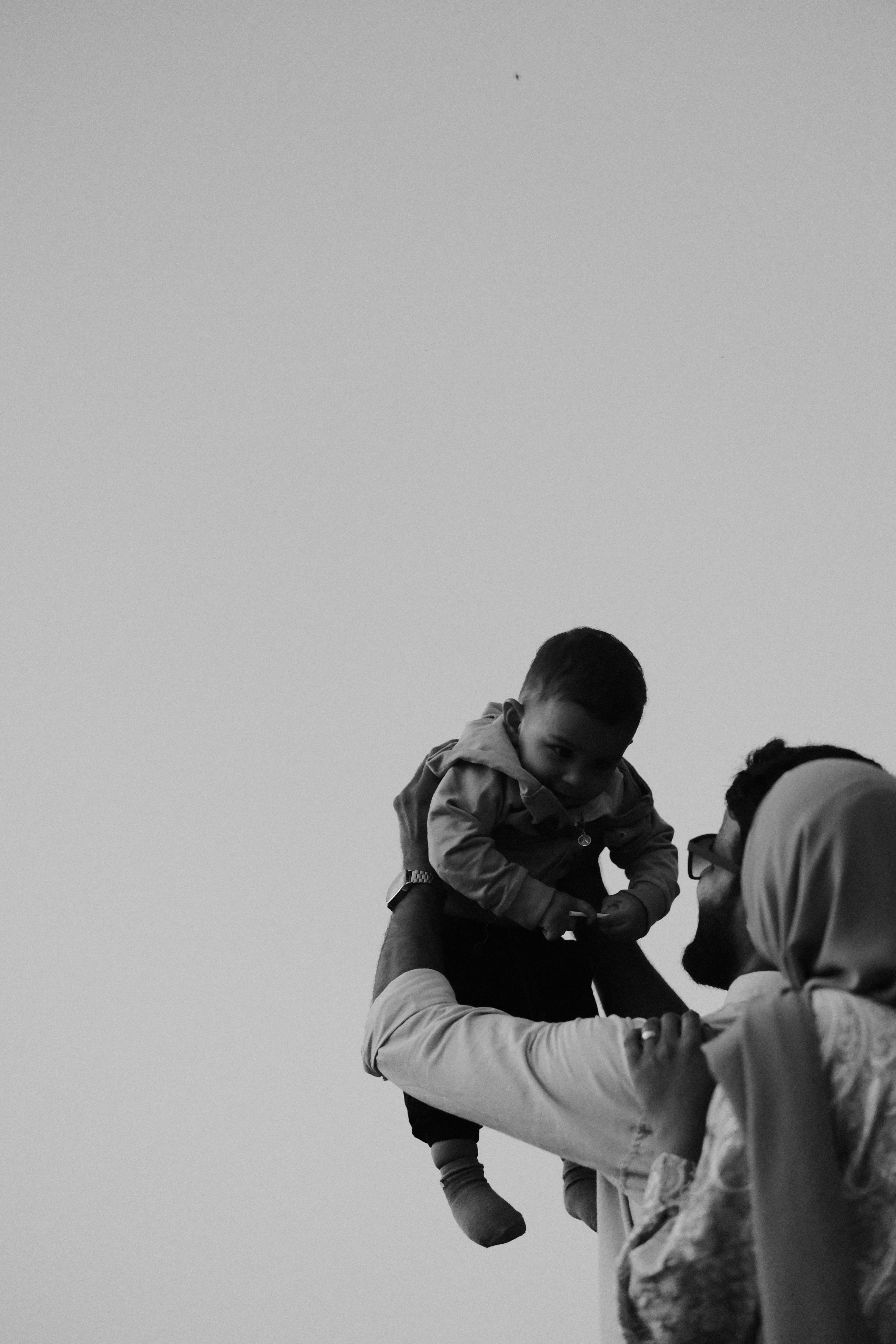 A black and white photo of a man holding a child