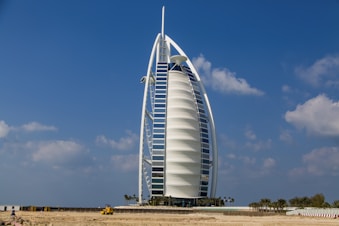 A tall building sitting on top of a sandy beach