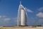 A tall building sitting on top of a sandy beach