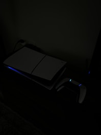 A laptop computer sitting on top of a desk in a dark room