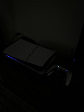 A laptop computer sitting on top of a desk in a dark room