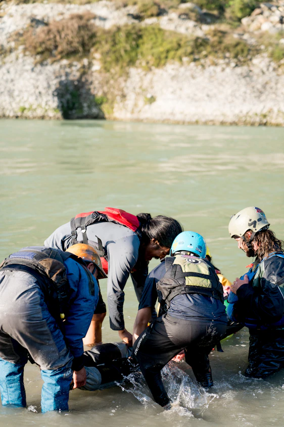 A group of people standing in the water