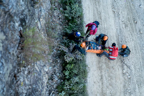 A group of people standing on top of a dirt road