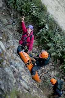 A woman is climbing up a steep hill