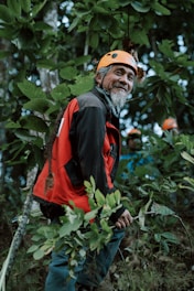 A man with a helmet standing in the woods