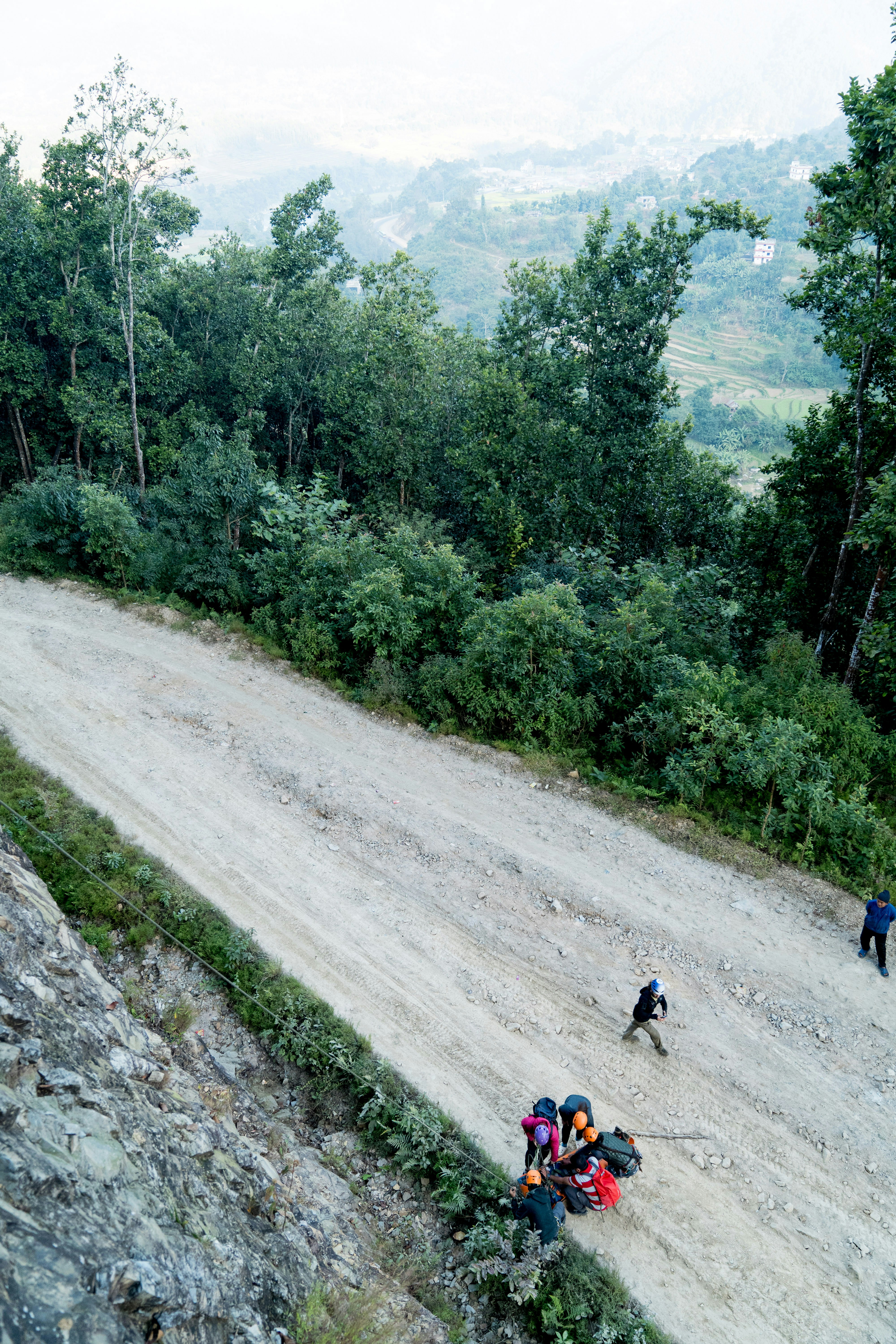 A group of people walking down a dirt road