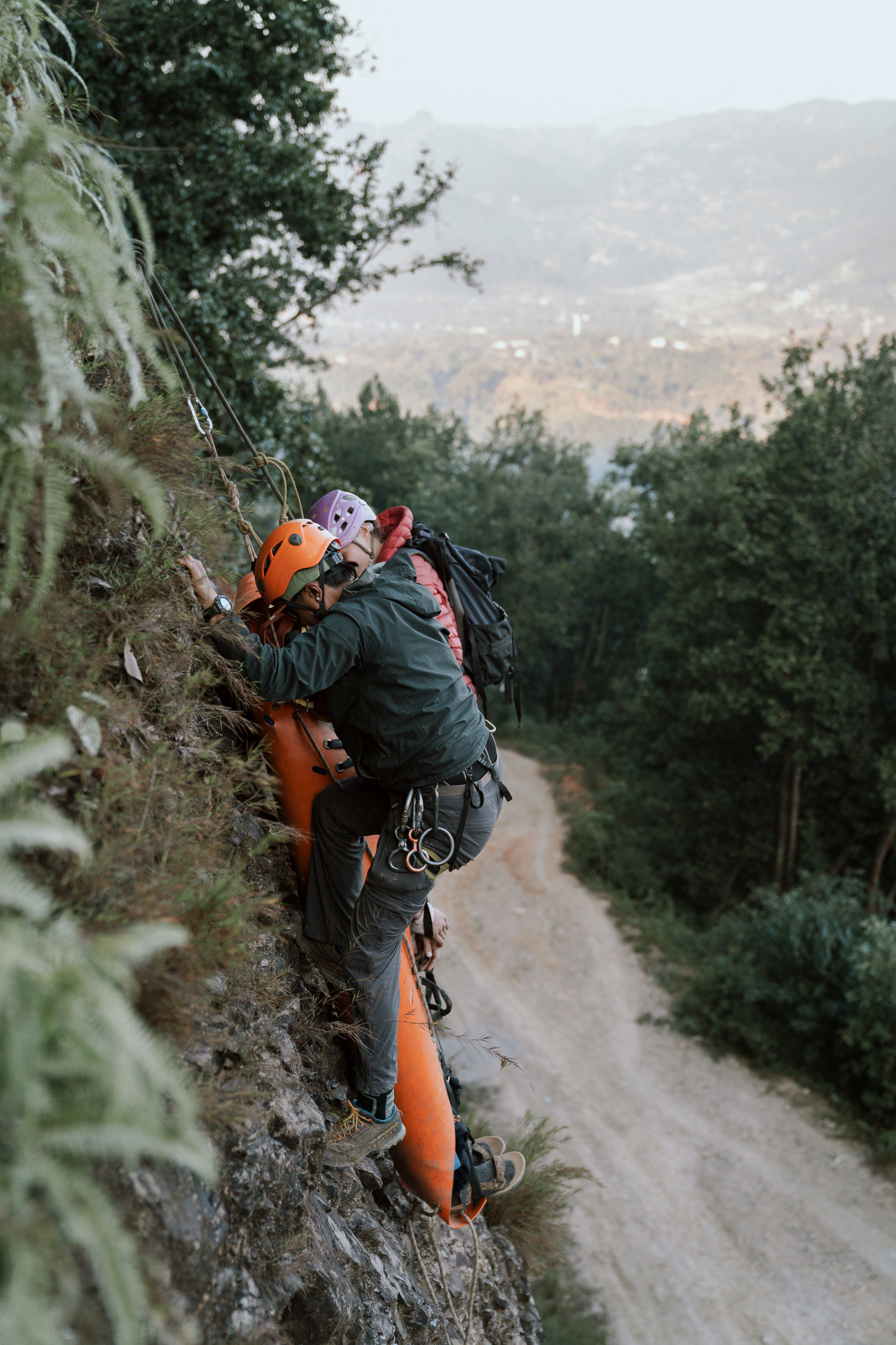 A man climbing up the side of a mountain photo – Free Man Image on Unsplash