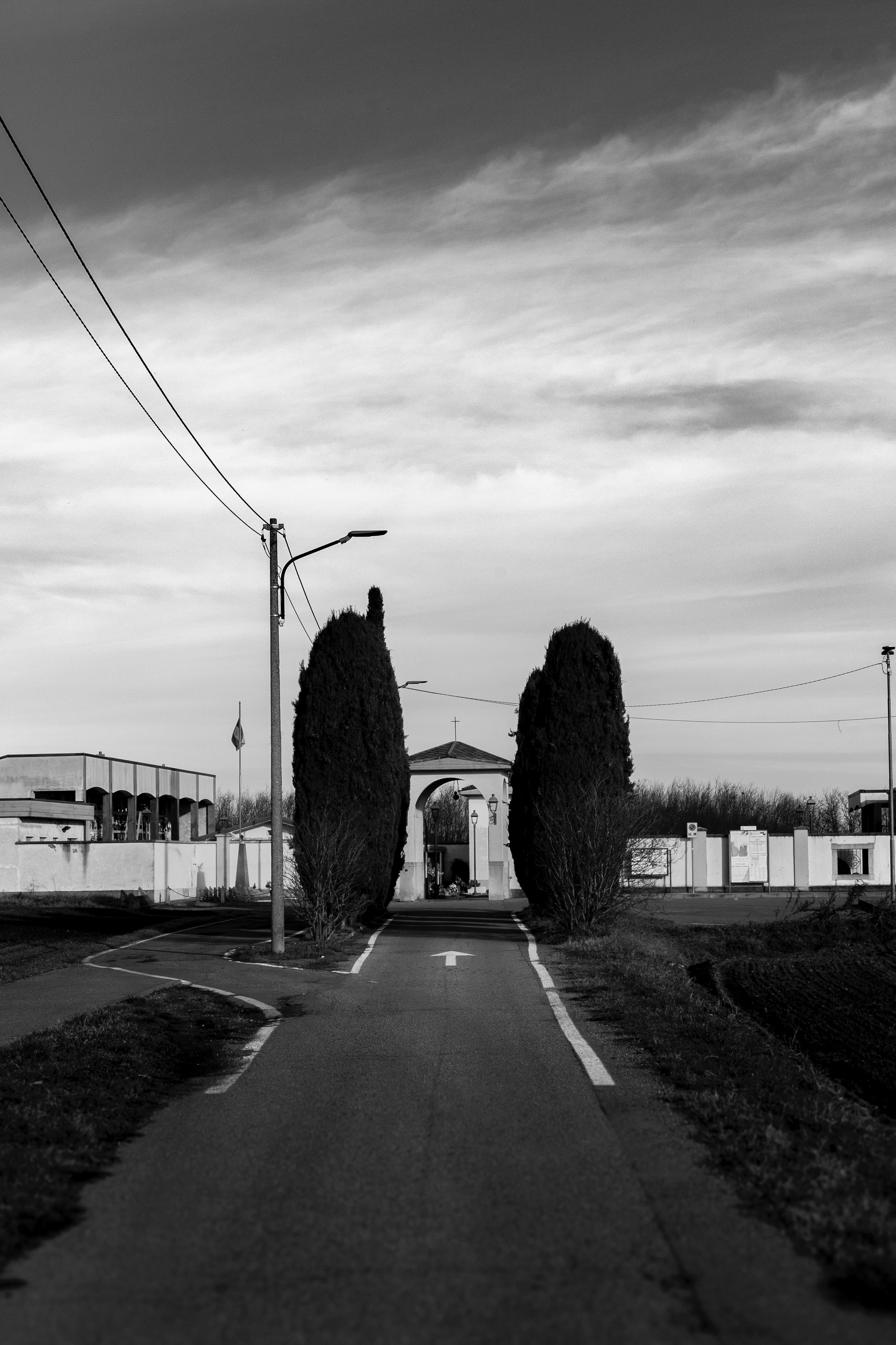 A black and white photo of an empty road