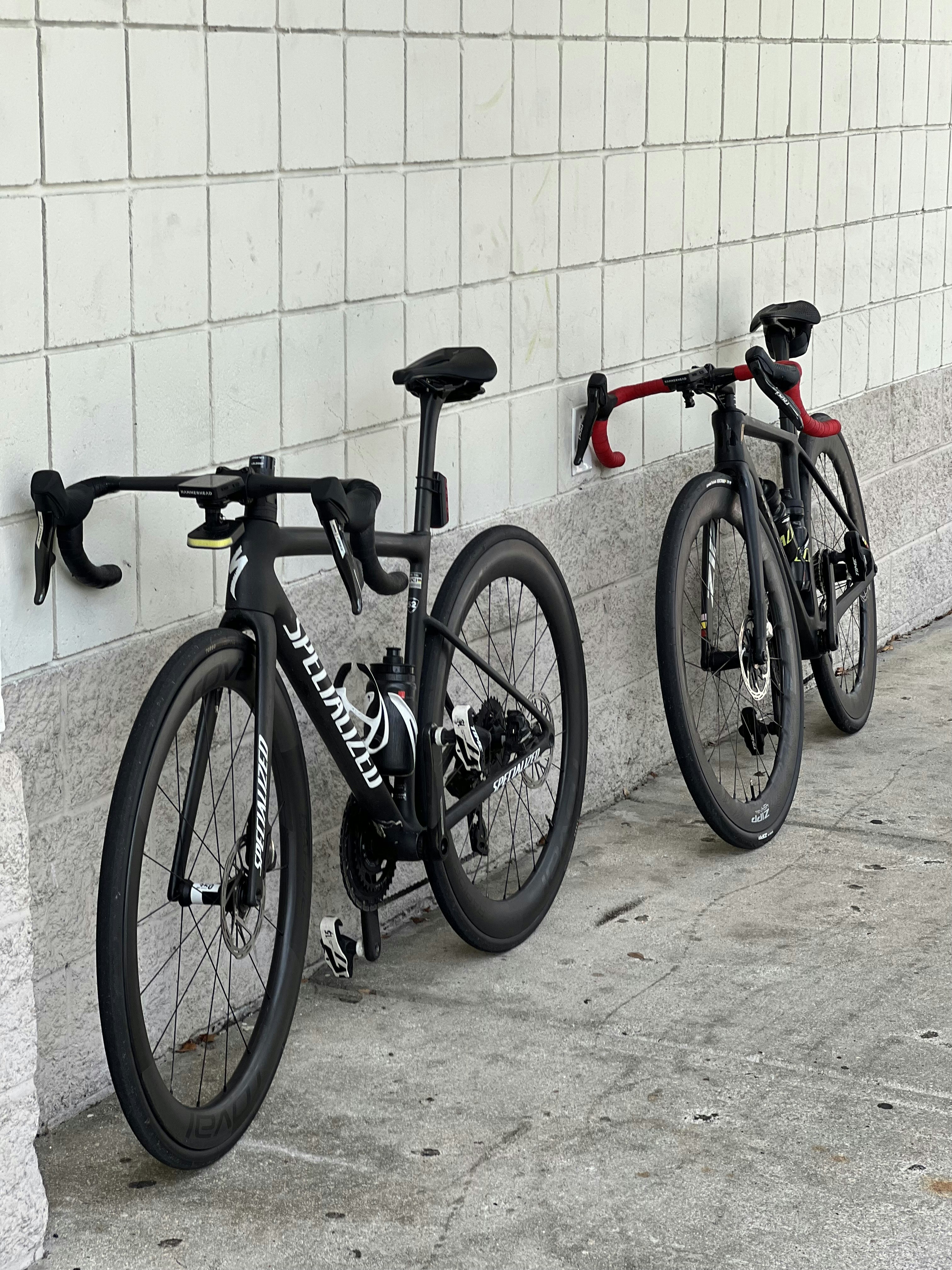 Red and white Specialized road bike leaning against wall