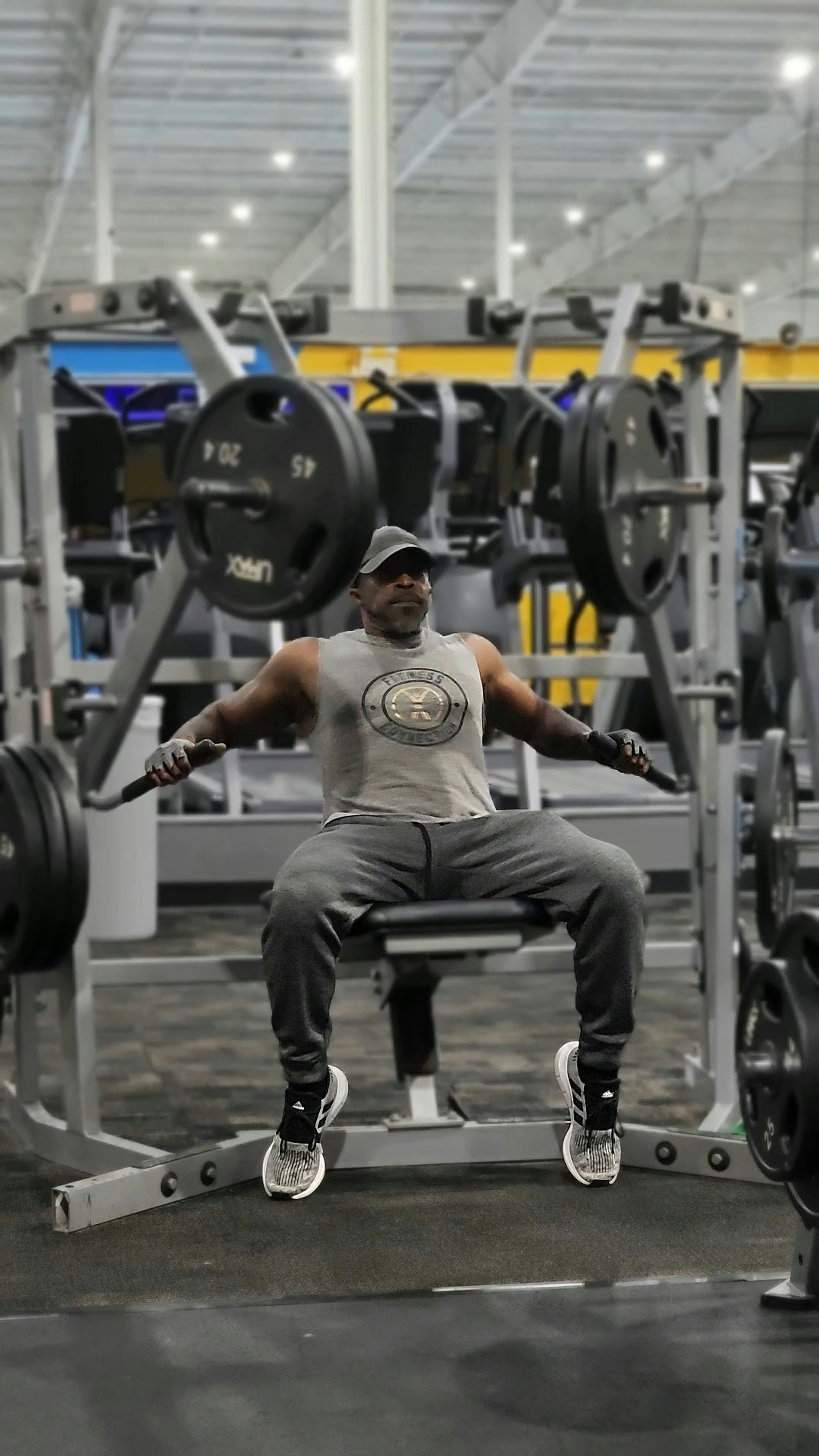 A man sitting on a bench in a gym