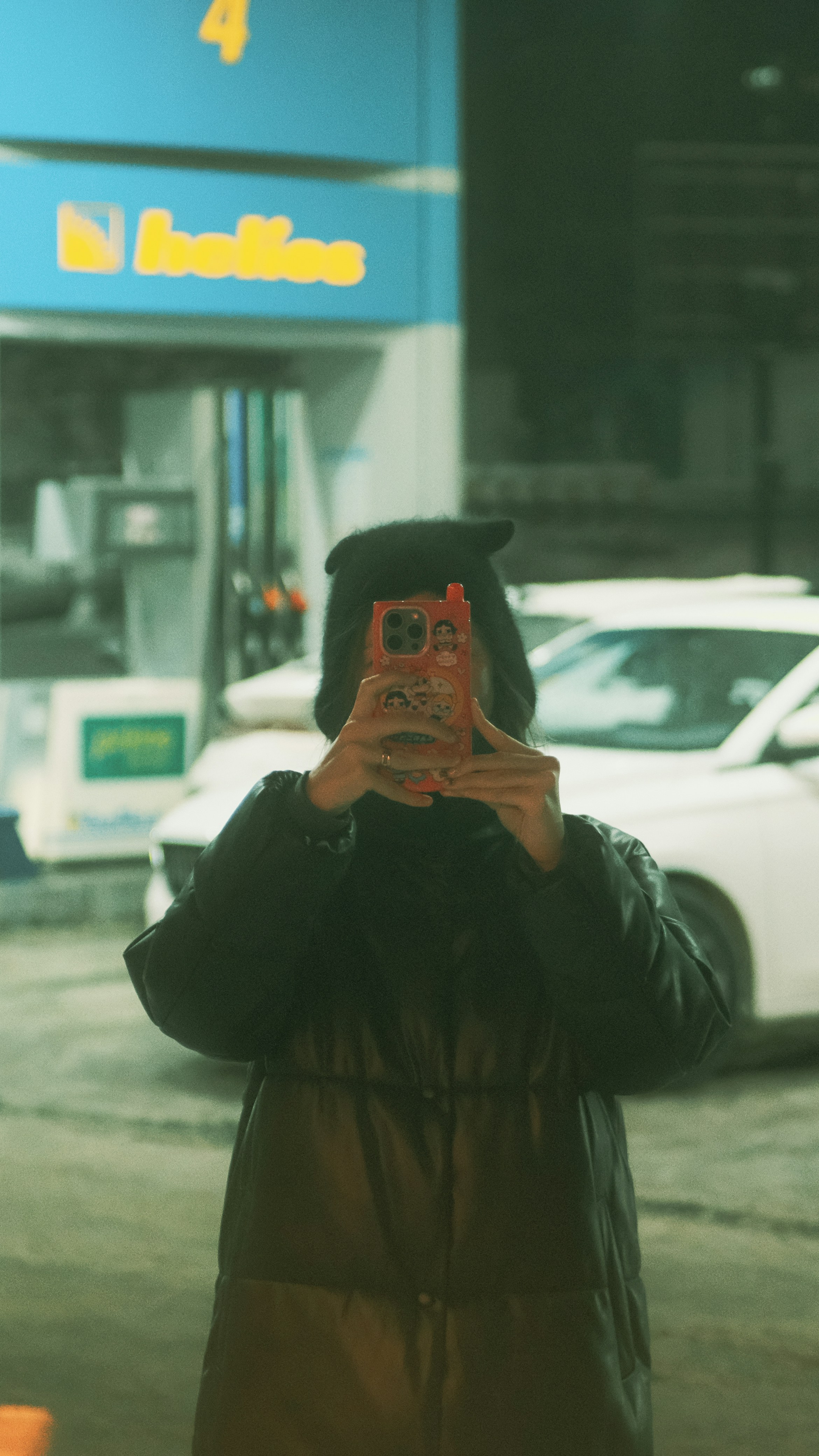 A woman taking a picture of herself with her cell phone