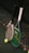 Two tennis rackets leaning against a chain link fence