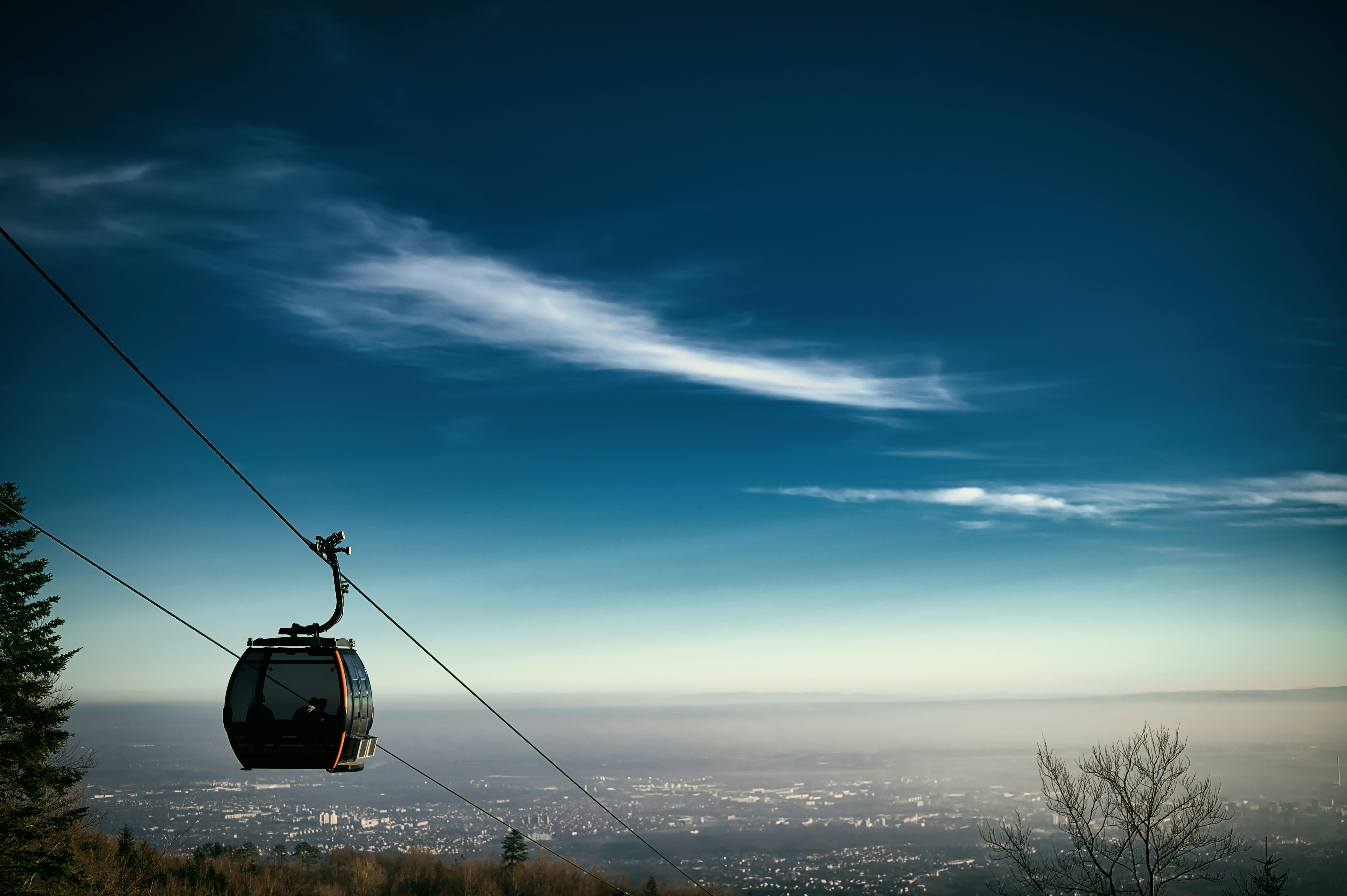 A ski lift with a view of the city below