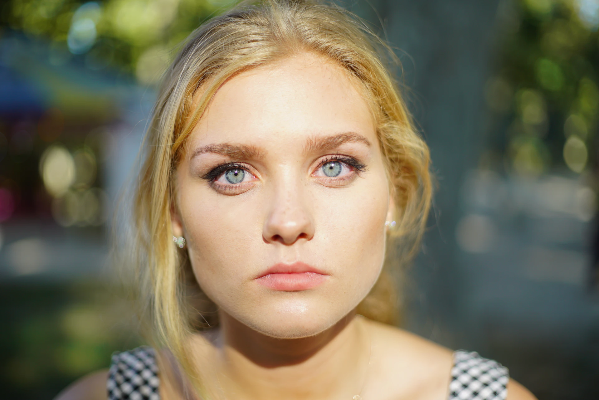 A woman with blue eyes is looking at the camera
