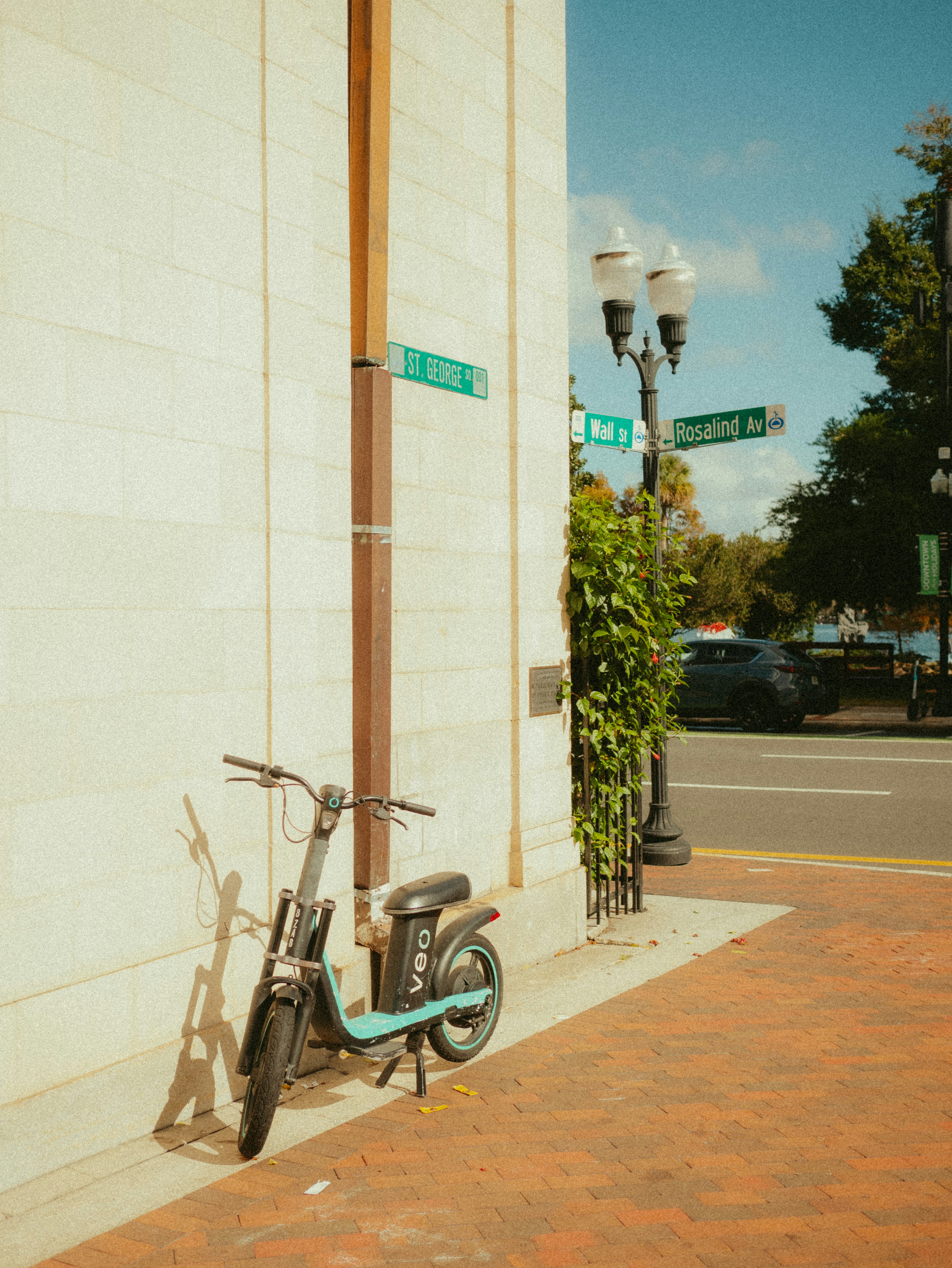 A scooter parked on the side of a building
