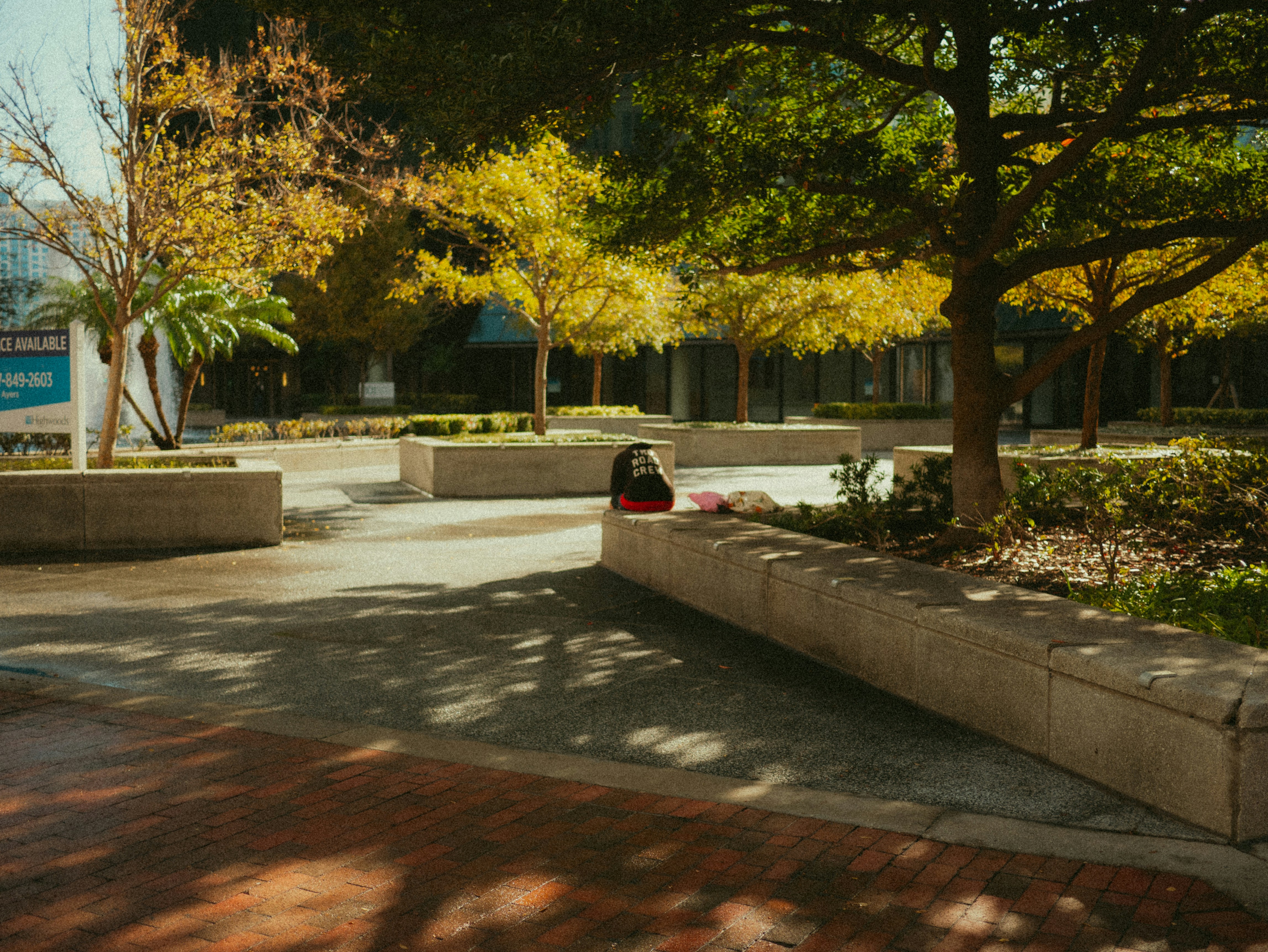 A man riding a skateboard down a sidewalk