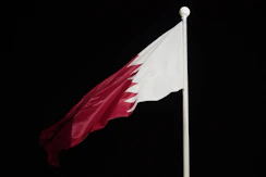 A red and white flag flying in the wind