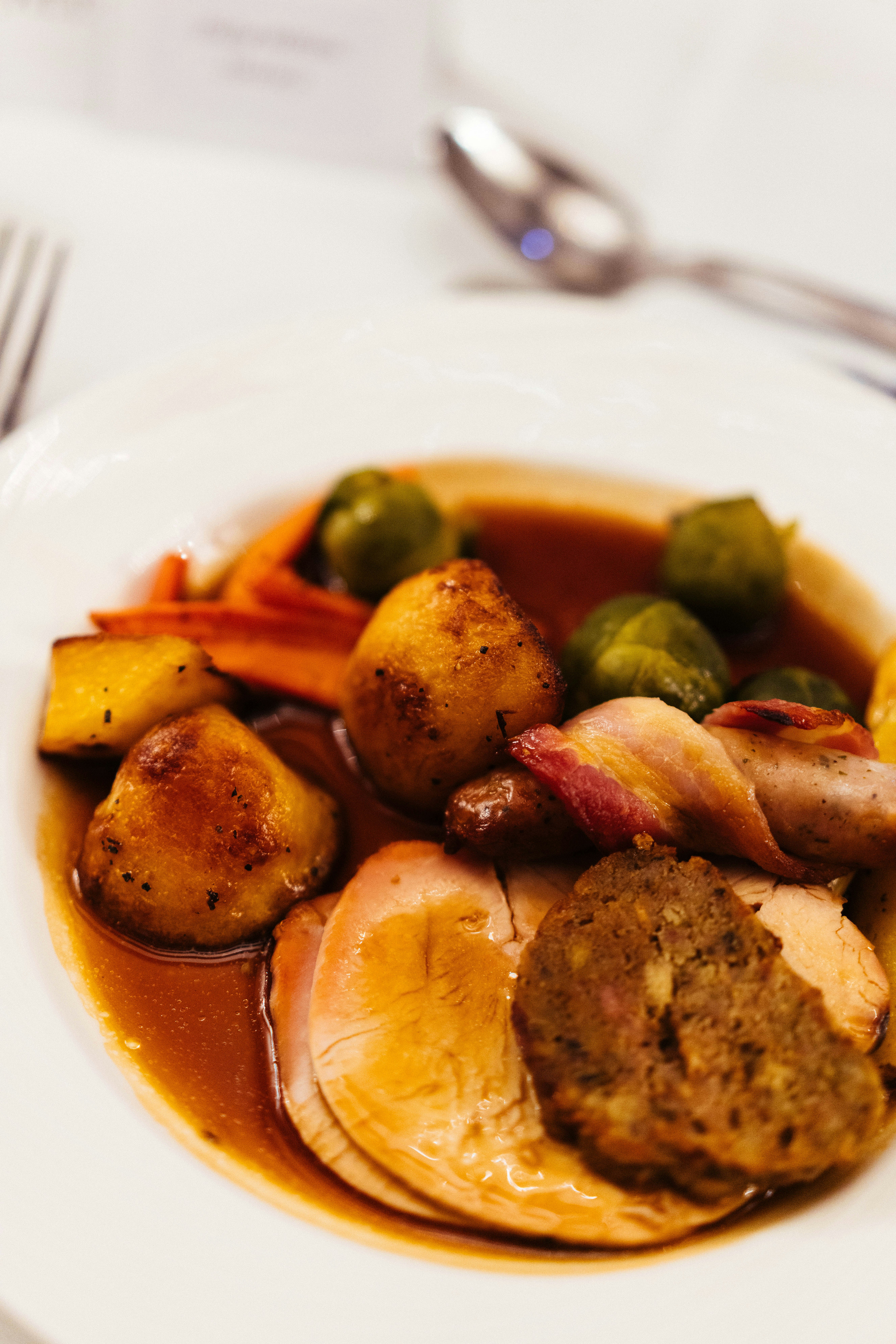 A white plate topped with meat and vegetables