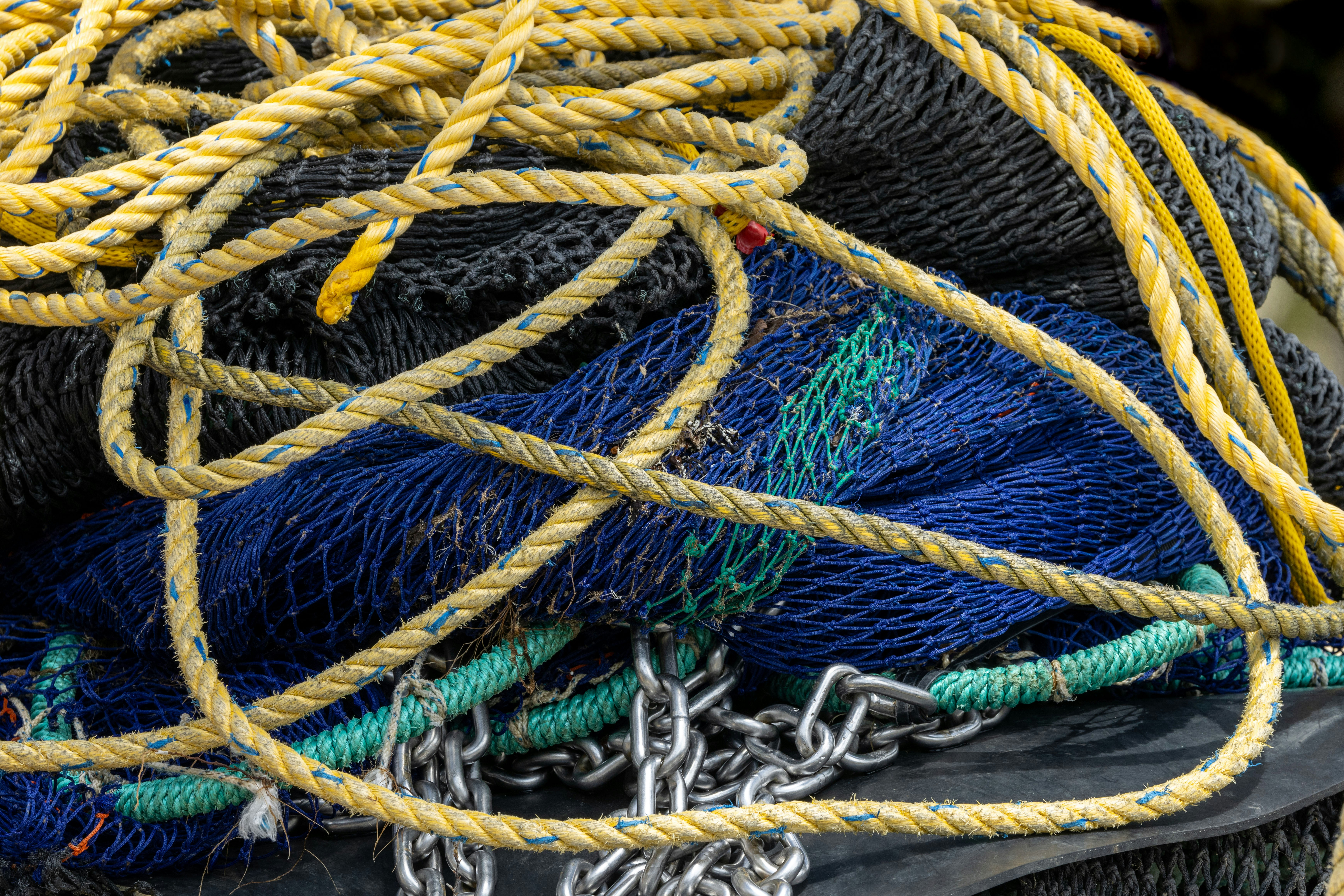 cord fishing net Tactical Fly Fisher magnet and elastic Designed with both fish and fishers in mind A pile of fishing nets