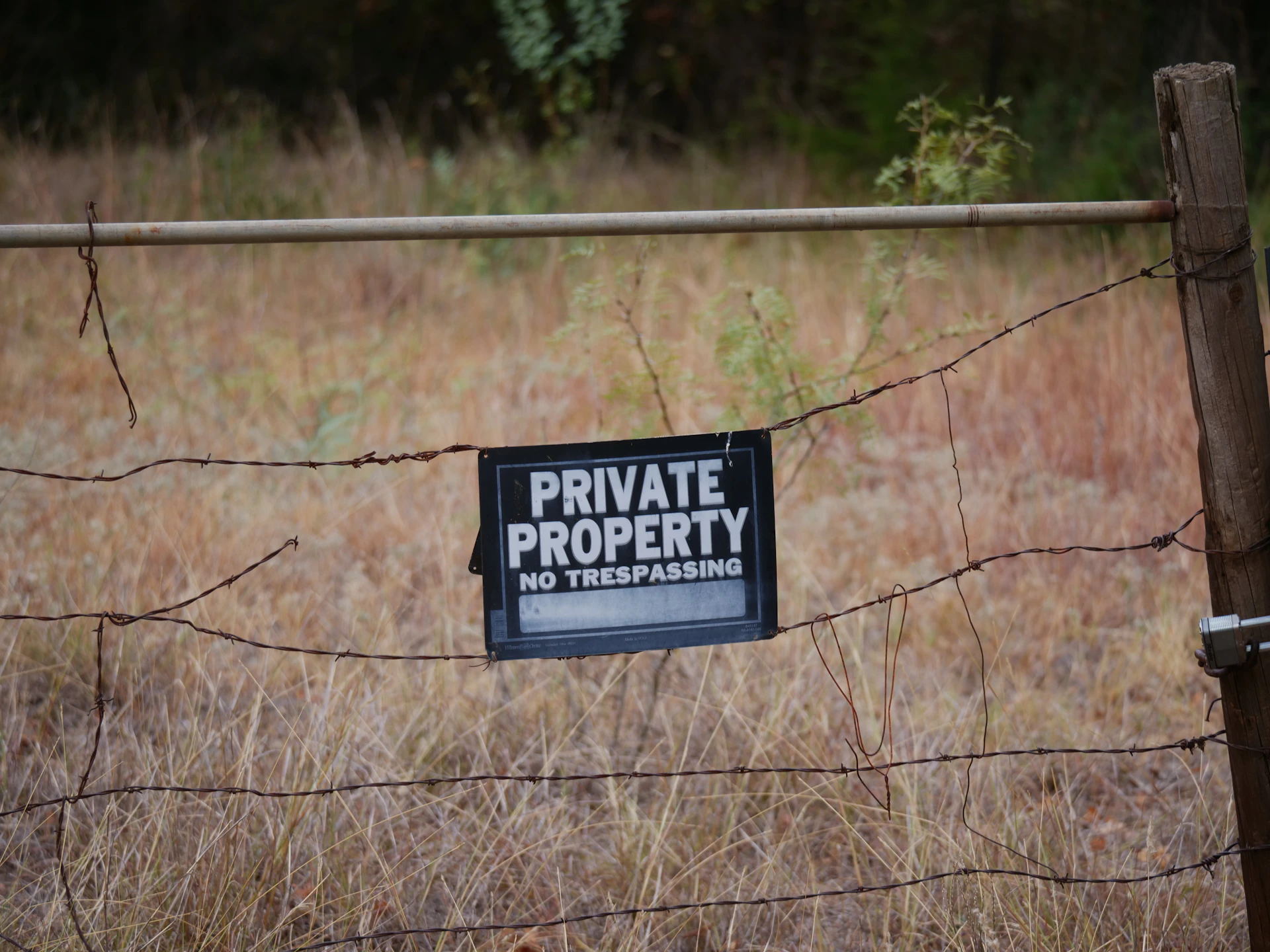 A private property sign is posted on a fence