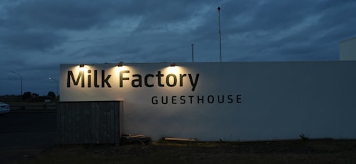 A sign that reads milk factory in front of a building