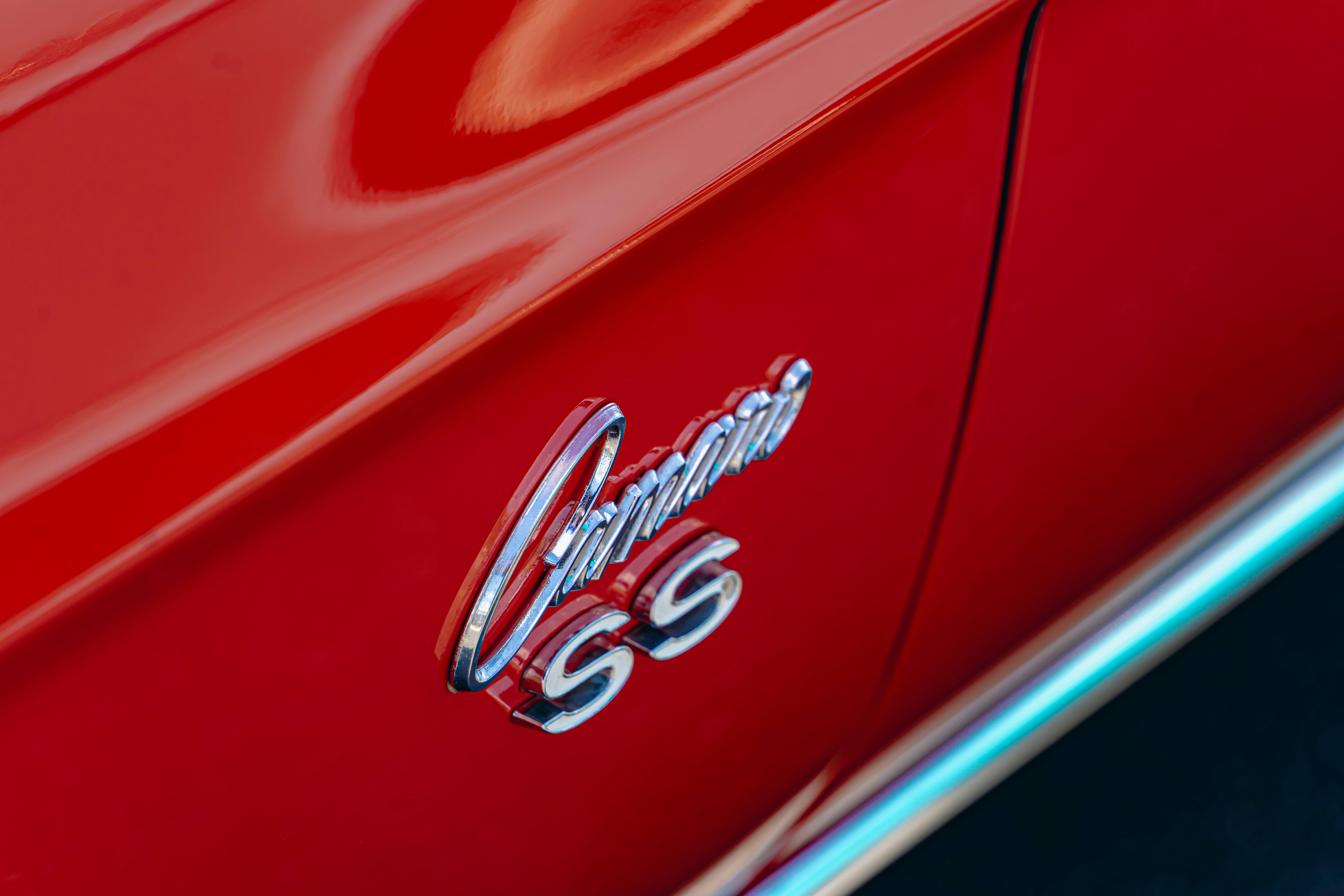 A close up of the emblem on a red car