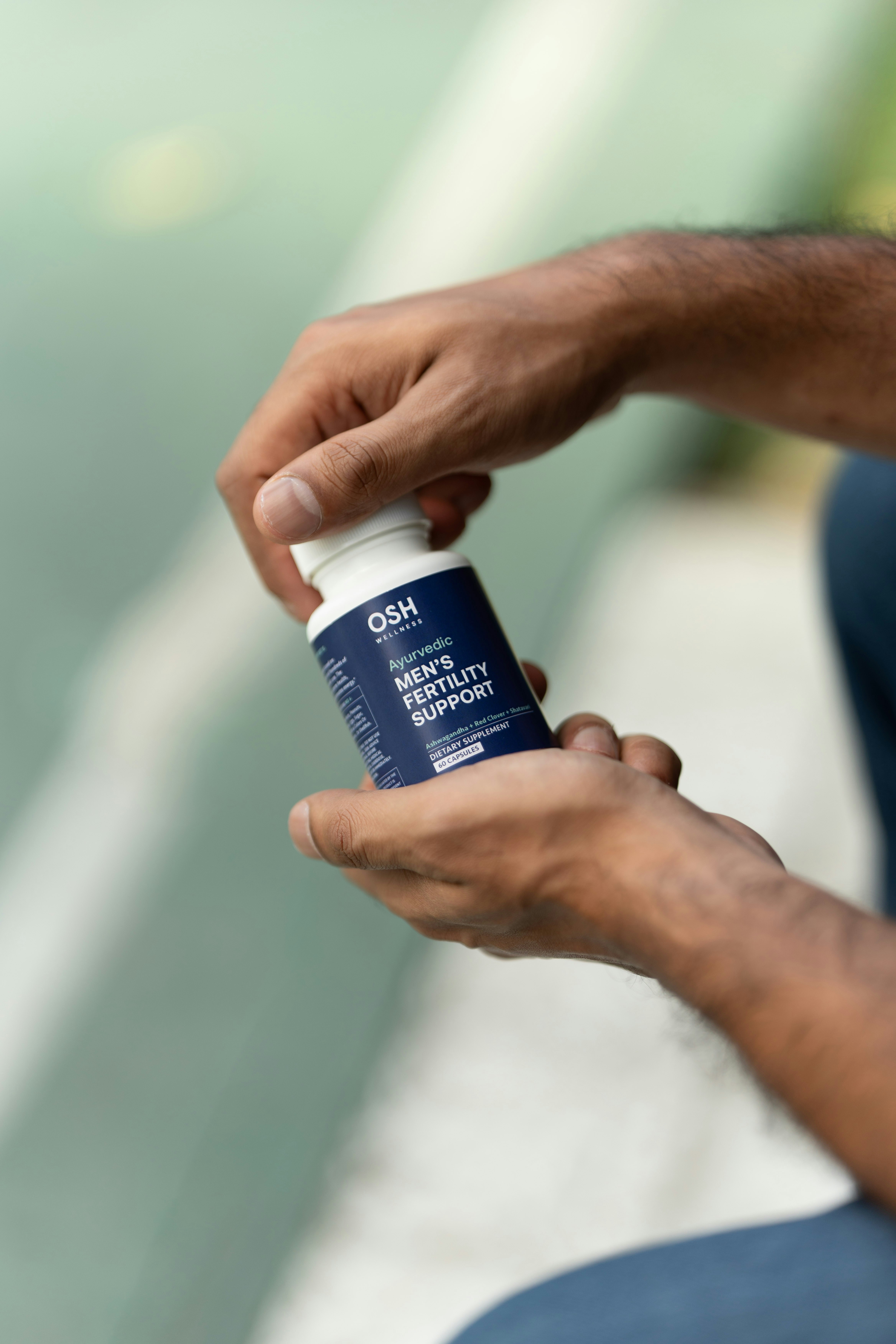 A man is holding a bottle of deodorant