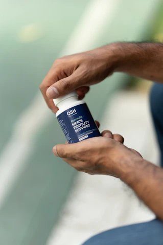 A man is holding a bottle of deodorant