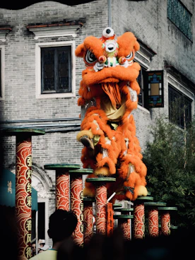 A large orange dragon statue in front of a building