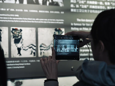 A woman taking a picture of a movie on her phone